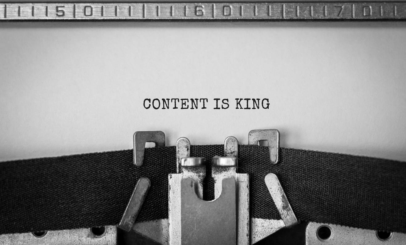 Close up of the words "content is king" on paper in a typewriter.