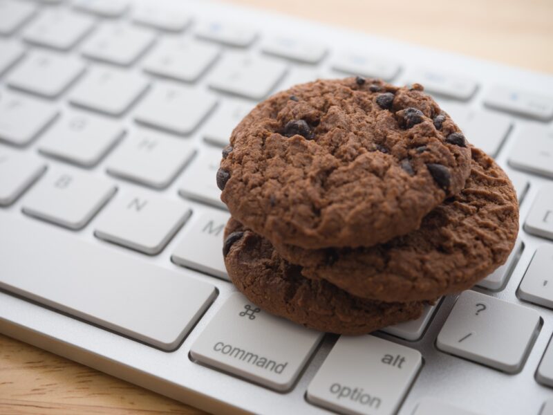 Chocolate cookies sit on a keyboard, signifying Google's elimination of third-party cookies for advertisers in 2024.